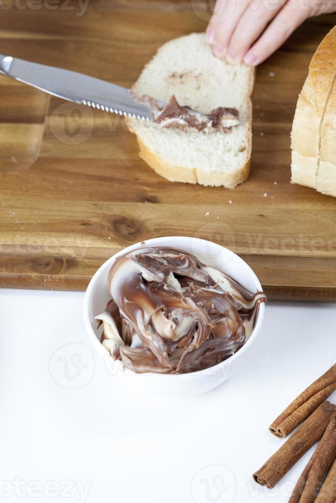 sliced white bread with smeared chocolate butter photo