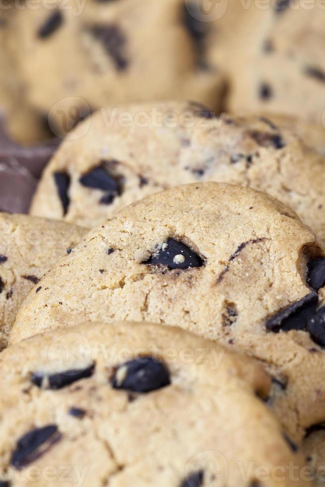 delicious wheat flour cookies and chocolate drops inside photo
