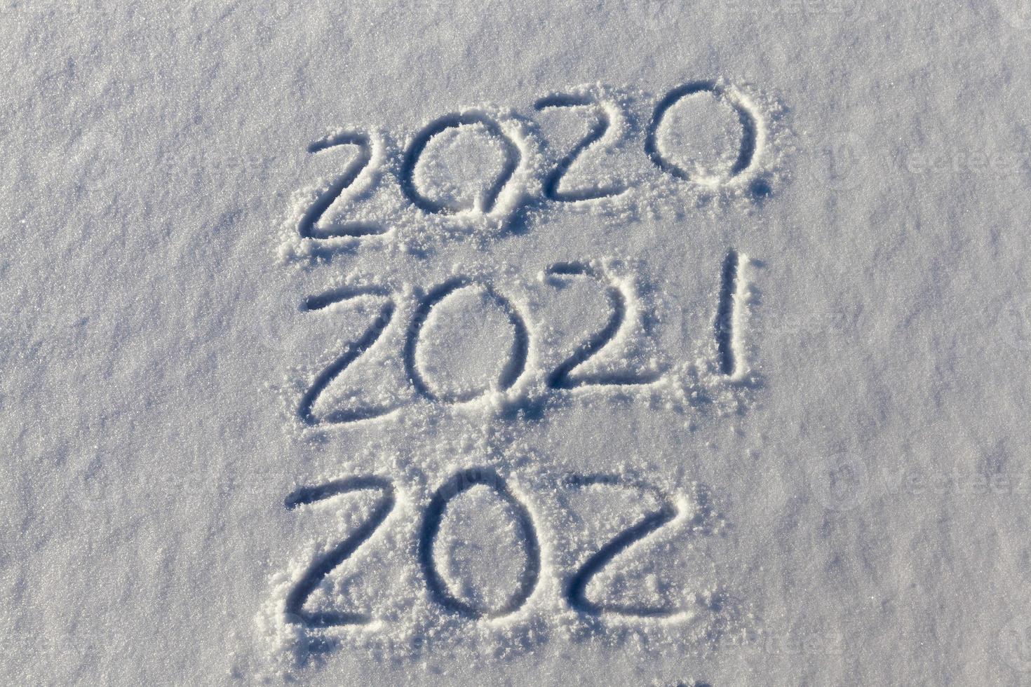 the inscription about the new year 2022 on the snow in winter photo