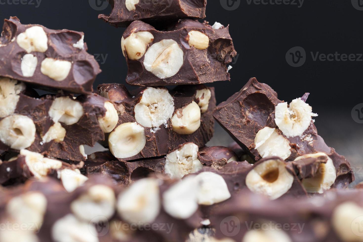 delicious milk homemade chocolate with lots of hazelnuts photo