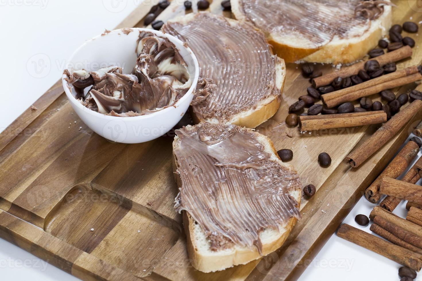 sliced white bread with smeared chocolate butter photo