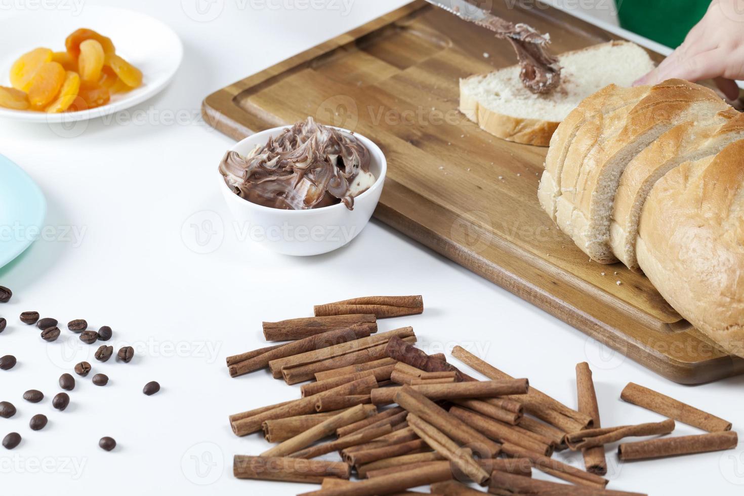 sliced white bread with smeared chocolate butter photo