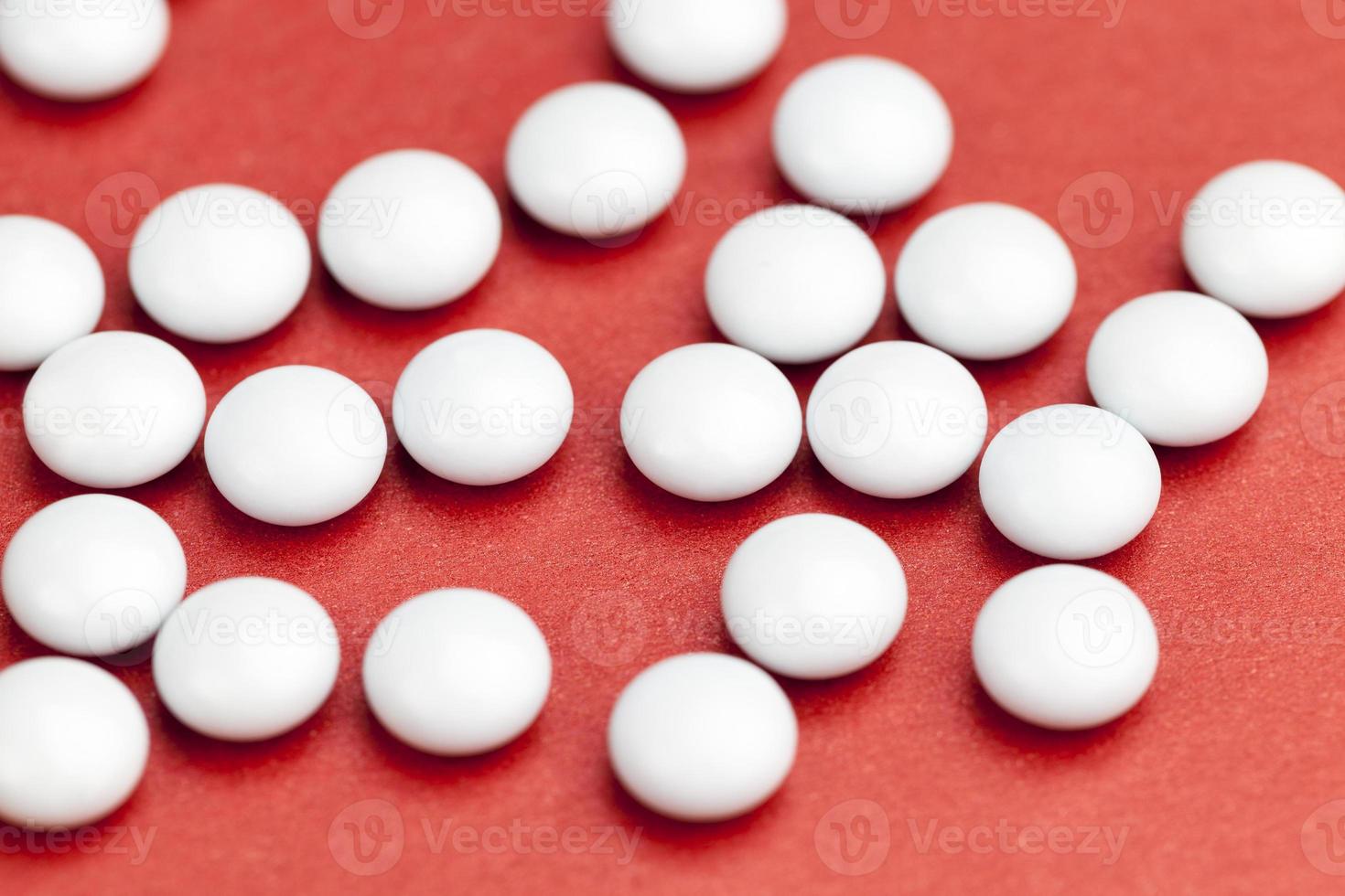 medicines for the treatment of diseases scattered on a red background photo