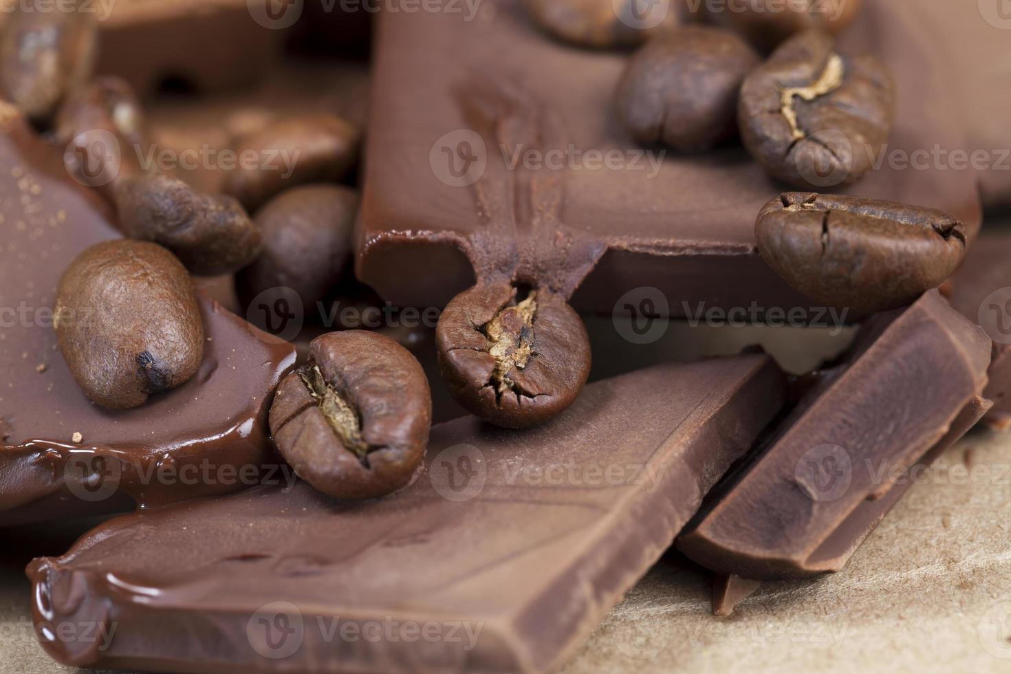 chocolate bar with cocoa powder topping and coffee beans photo