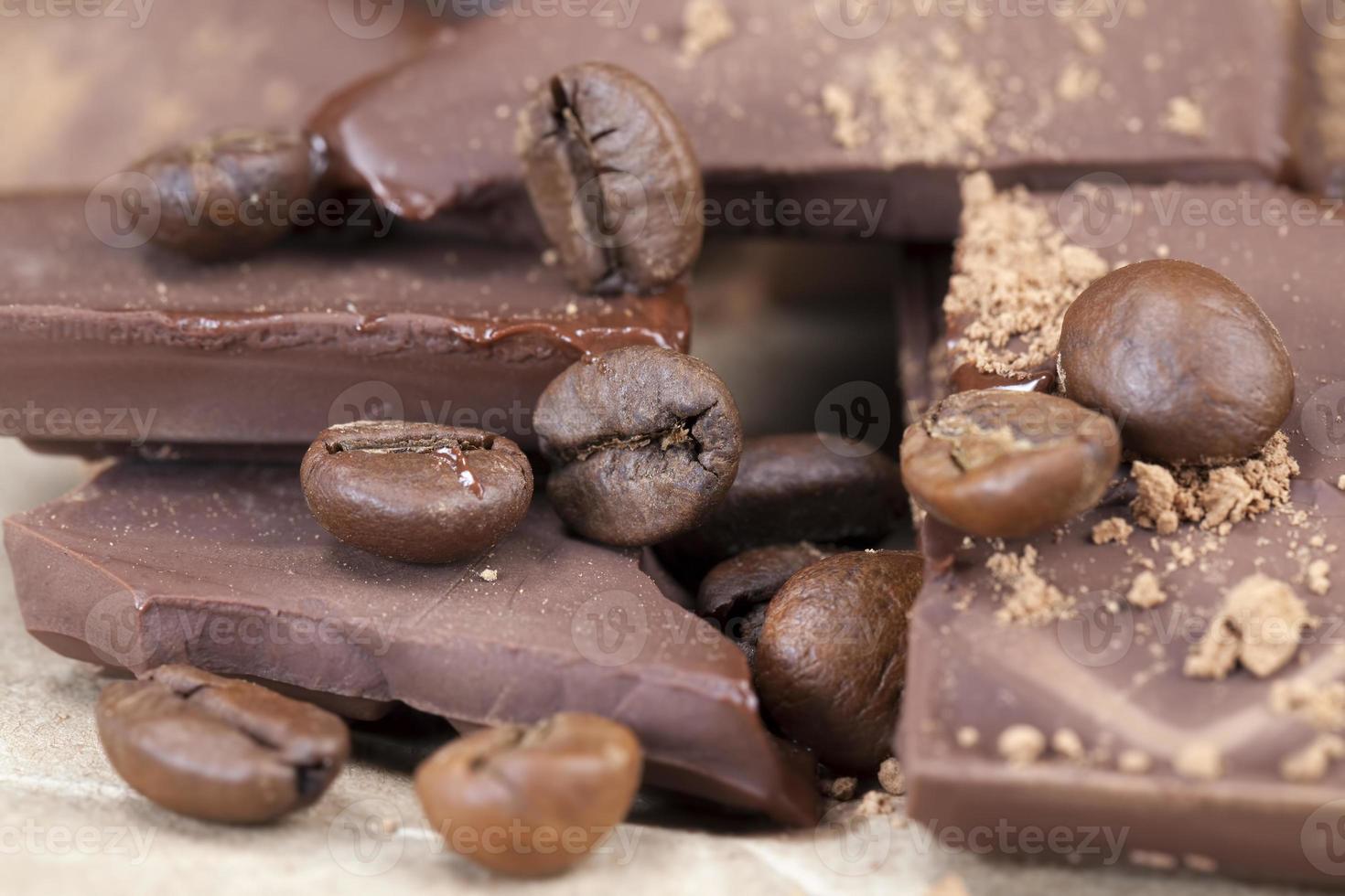 chocolate bar with cocoa powder topping and coffee beans photo