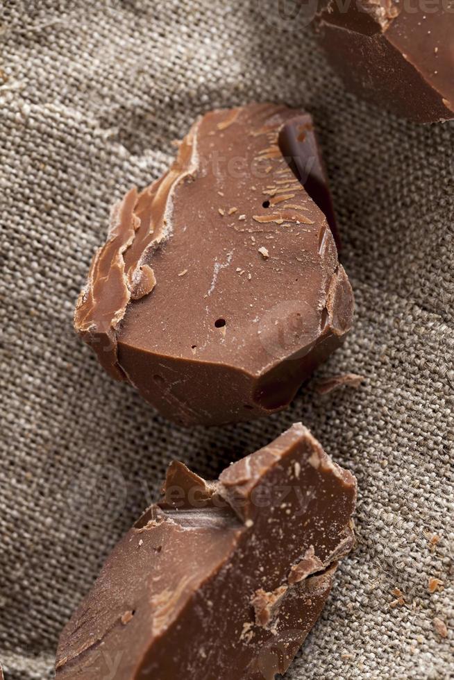 broken into several parts pieces of chocolate from cocoa photo