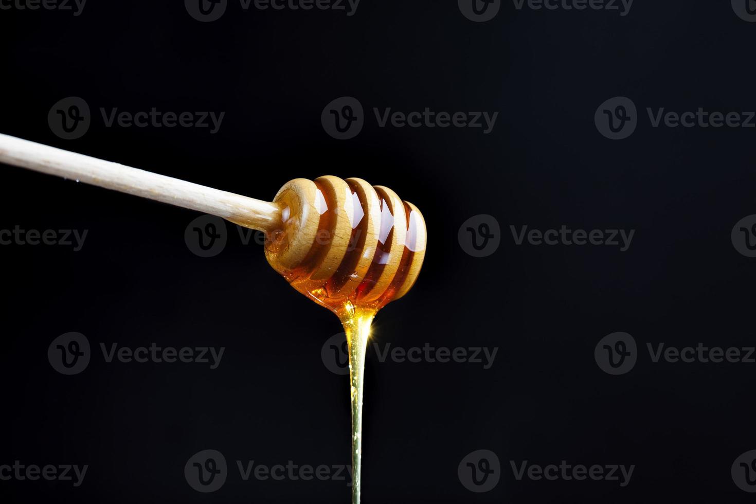 a spoon for honey together with high quality bee honey photo