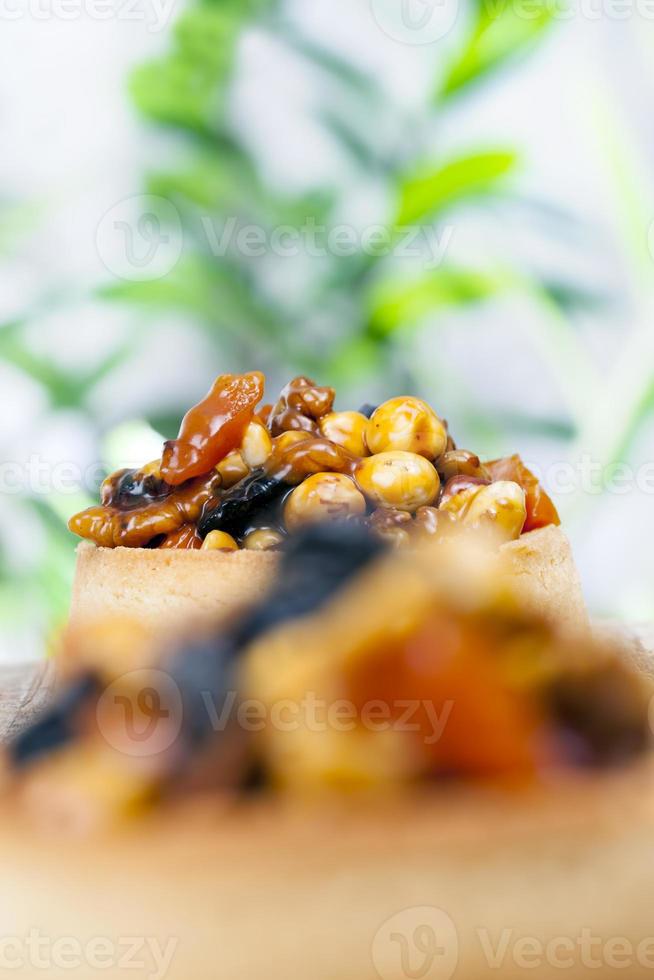 small round tartlet with a variety of fillings photo