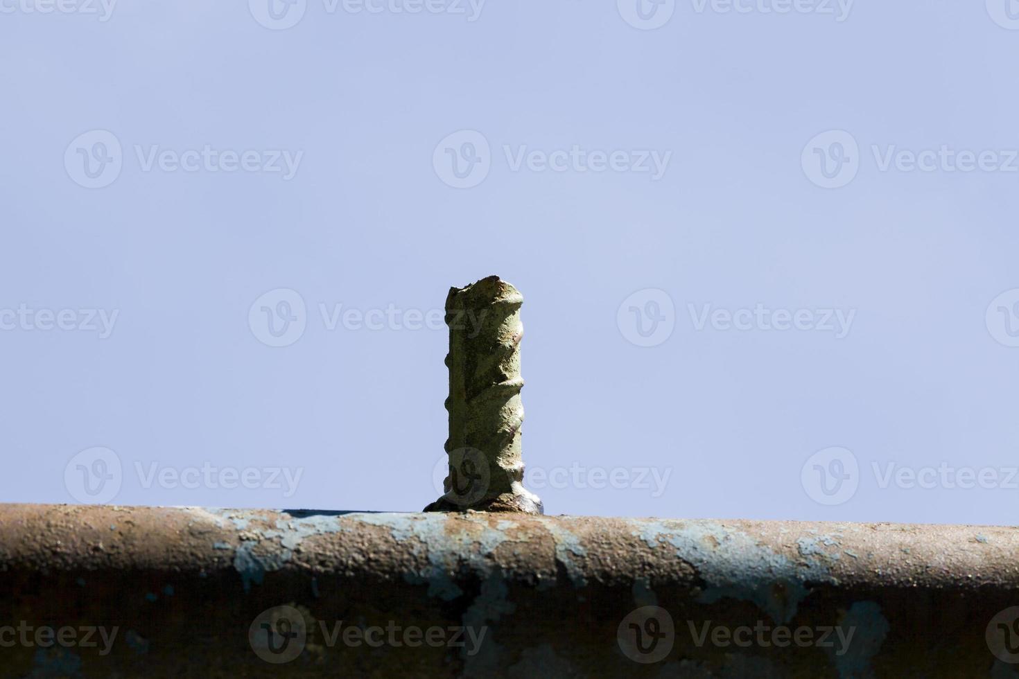 the part of the metal surface with protruding pieces of rebar photo