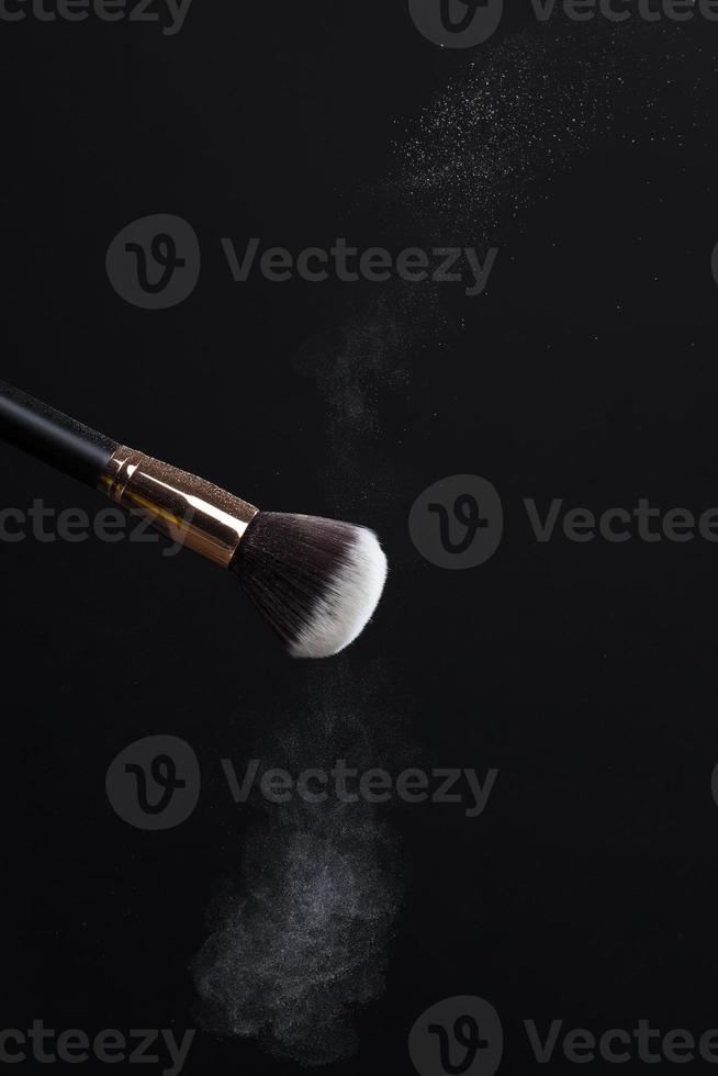 professional cosmetic brush with cosmetic product, close up photo
