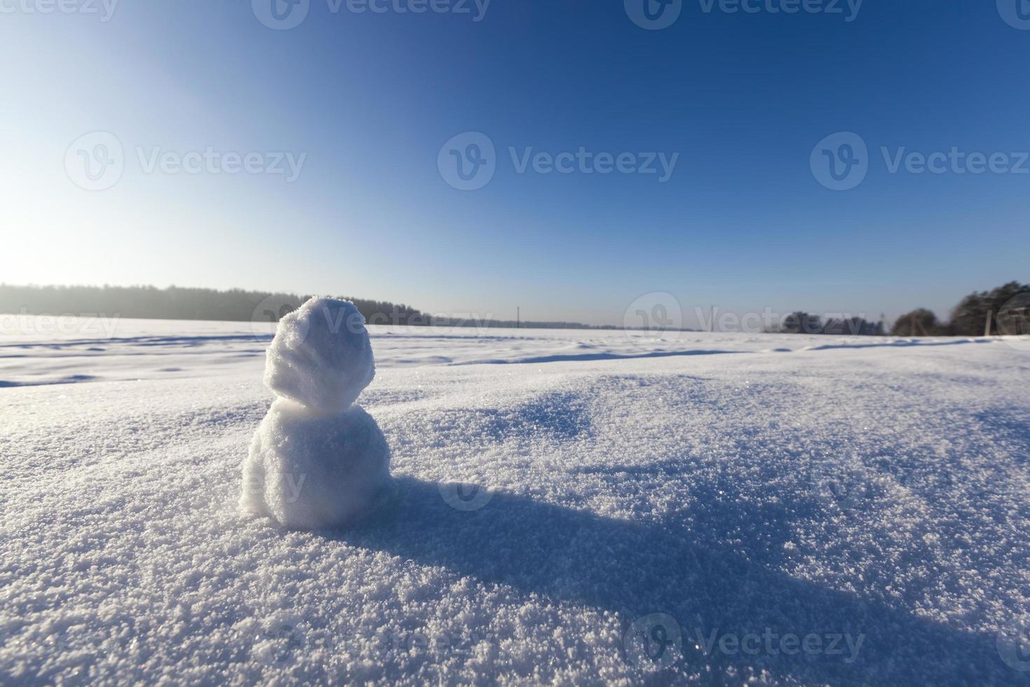 one small snowman in the winter season, close up photo