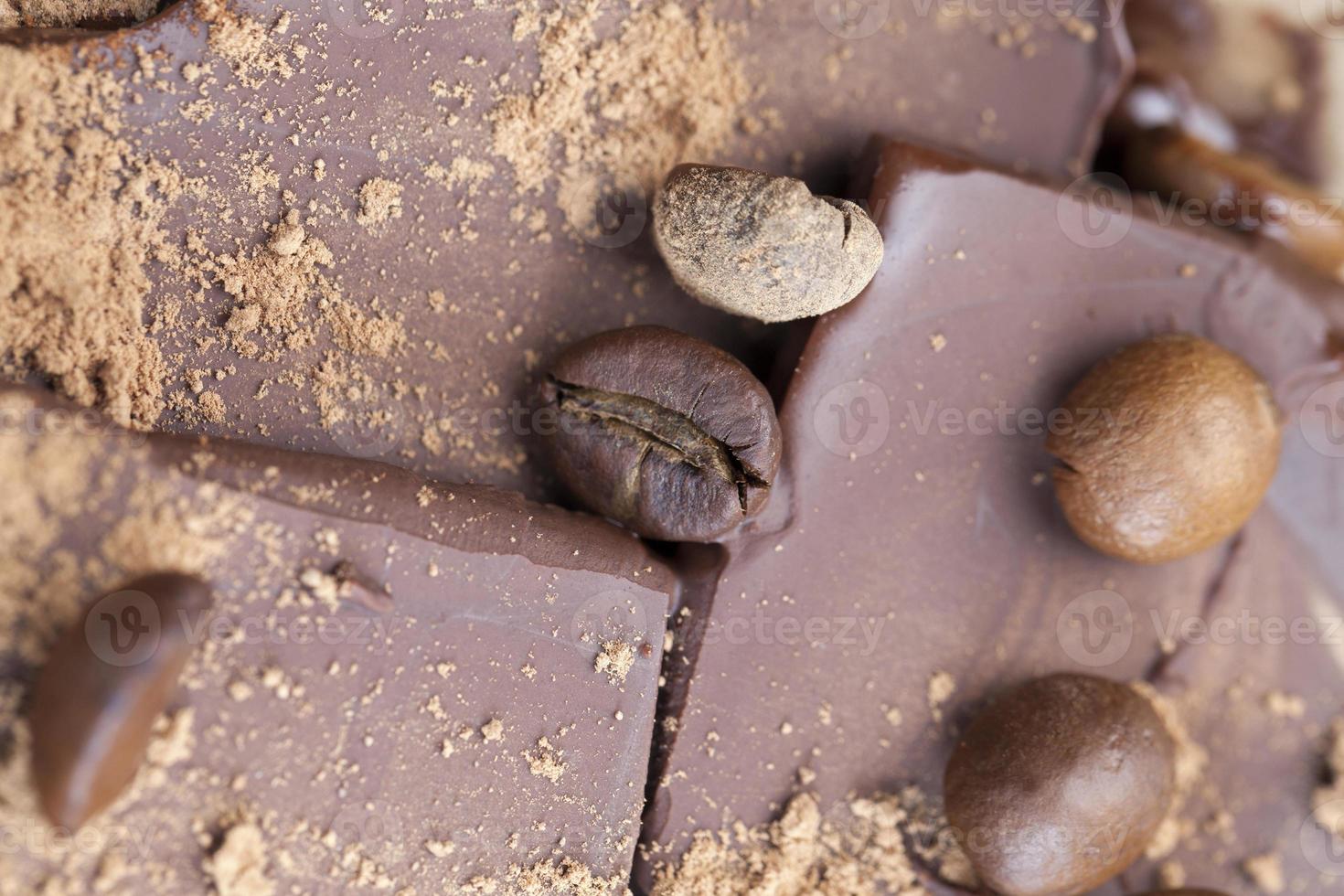 chocolate bar with cocoa powder topping and coffee beans photo