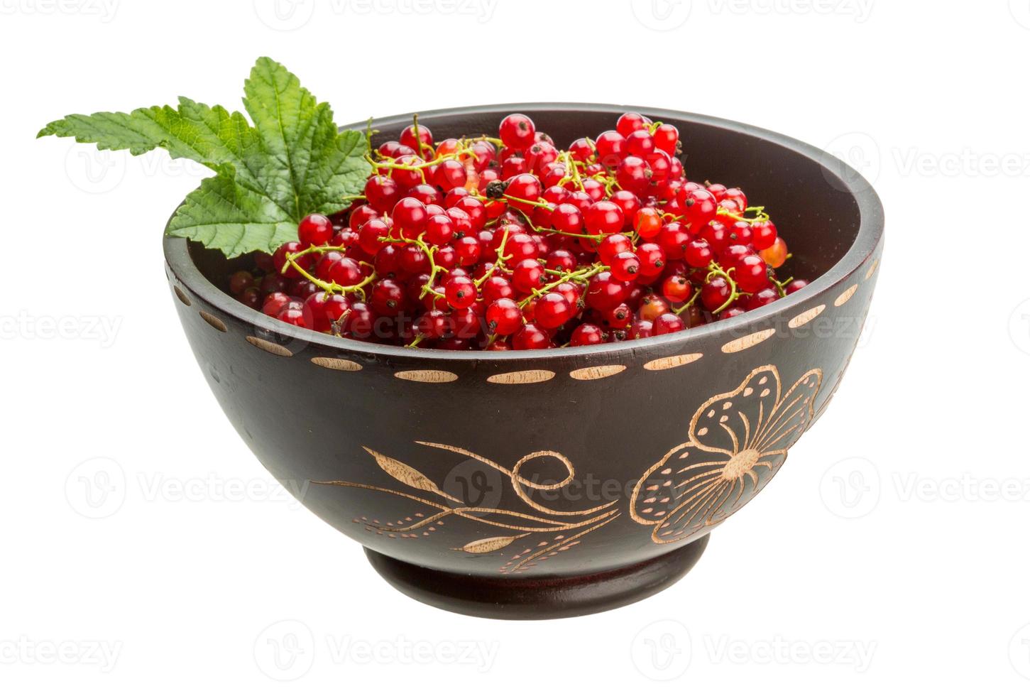 Red currant in a bowl on white background photo