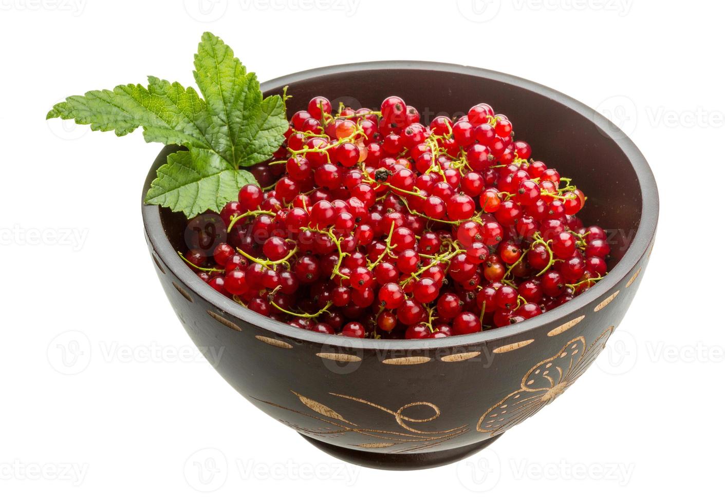 Red currant in a bowl on white background photo