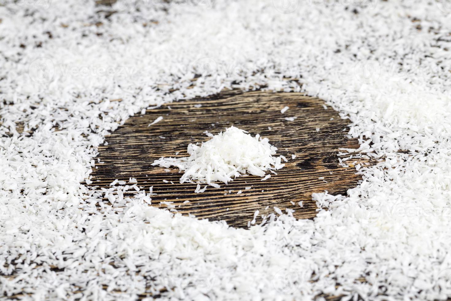 a fresh doughnut covered with white chocolate and coconut photo
