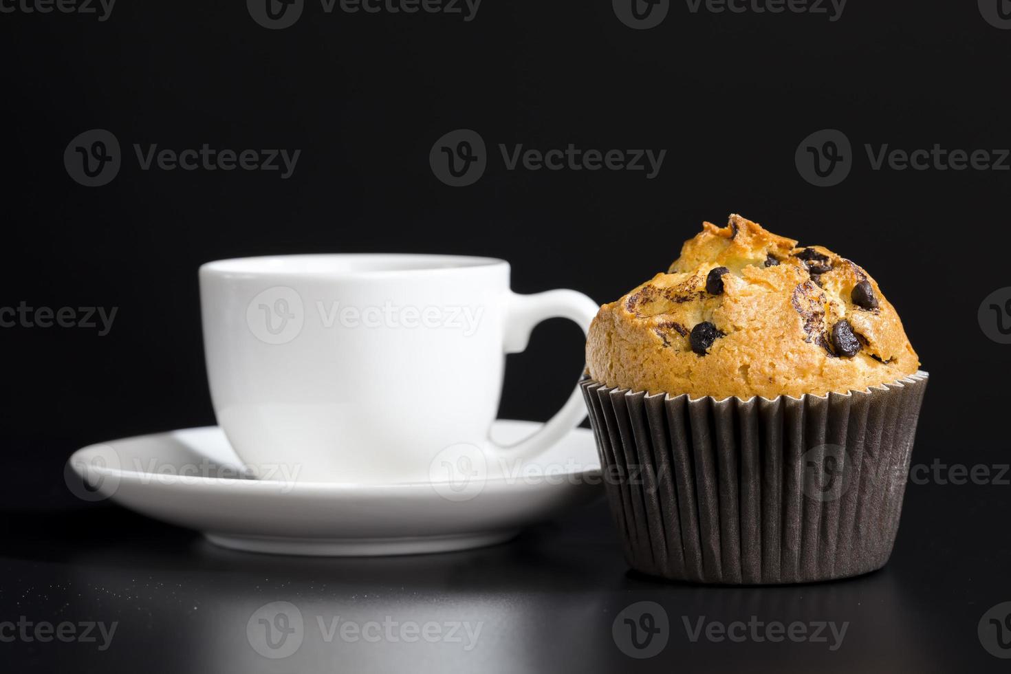 a delicious fresh bun and a cup of black aromatic coffee photo