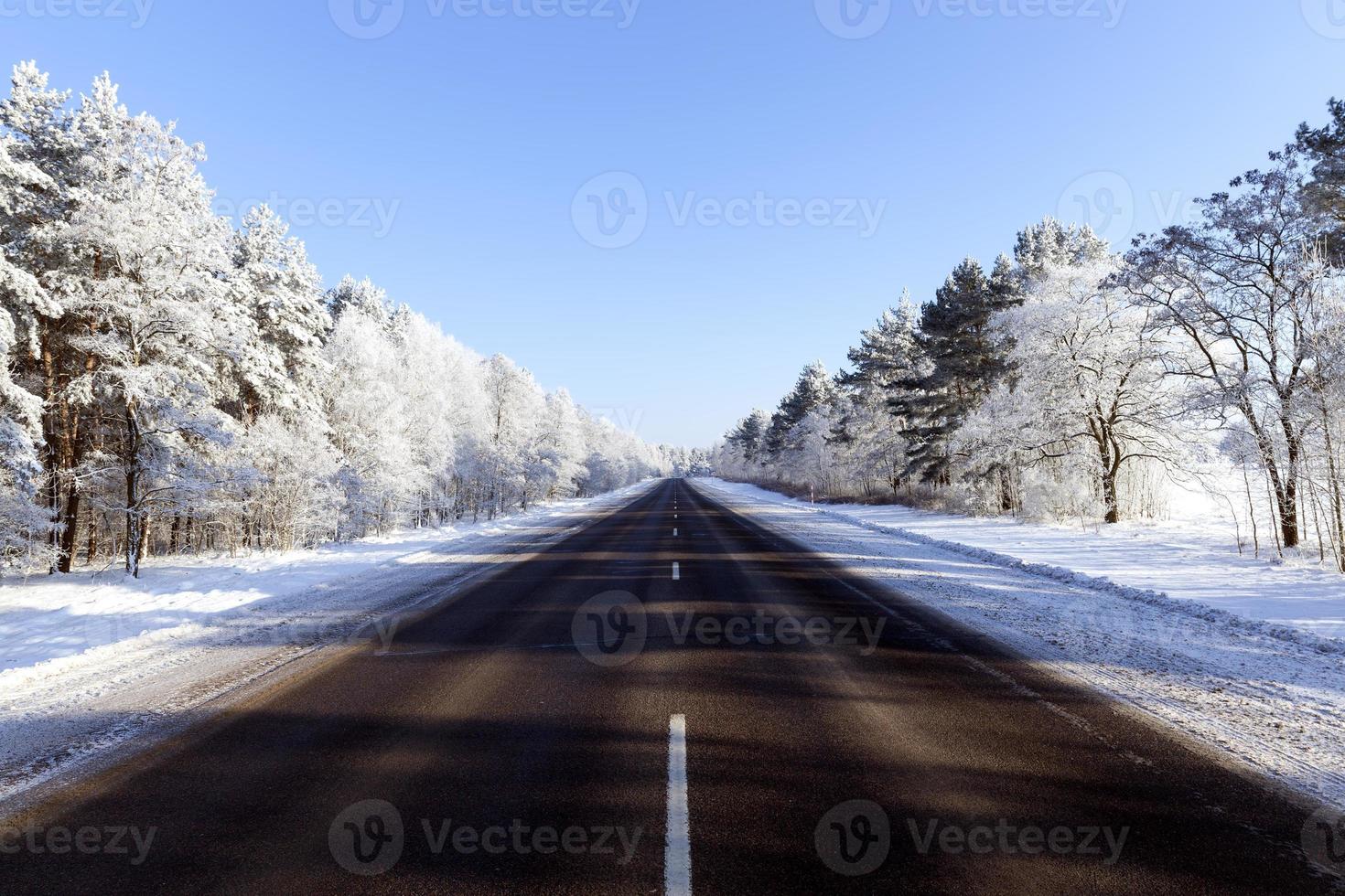 snowfall in the winter season and road asphalted photo