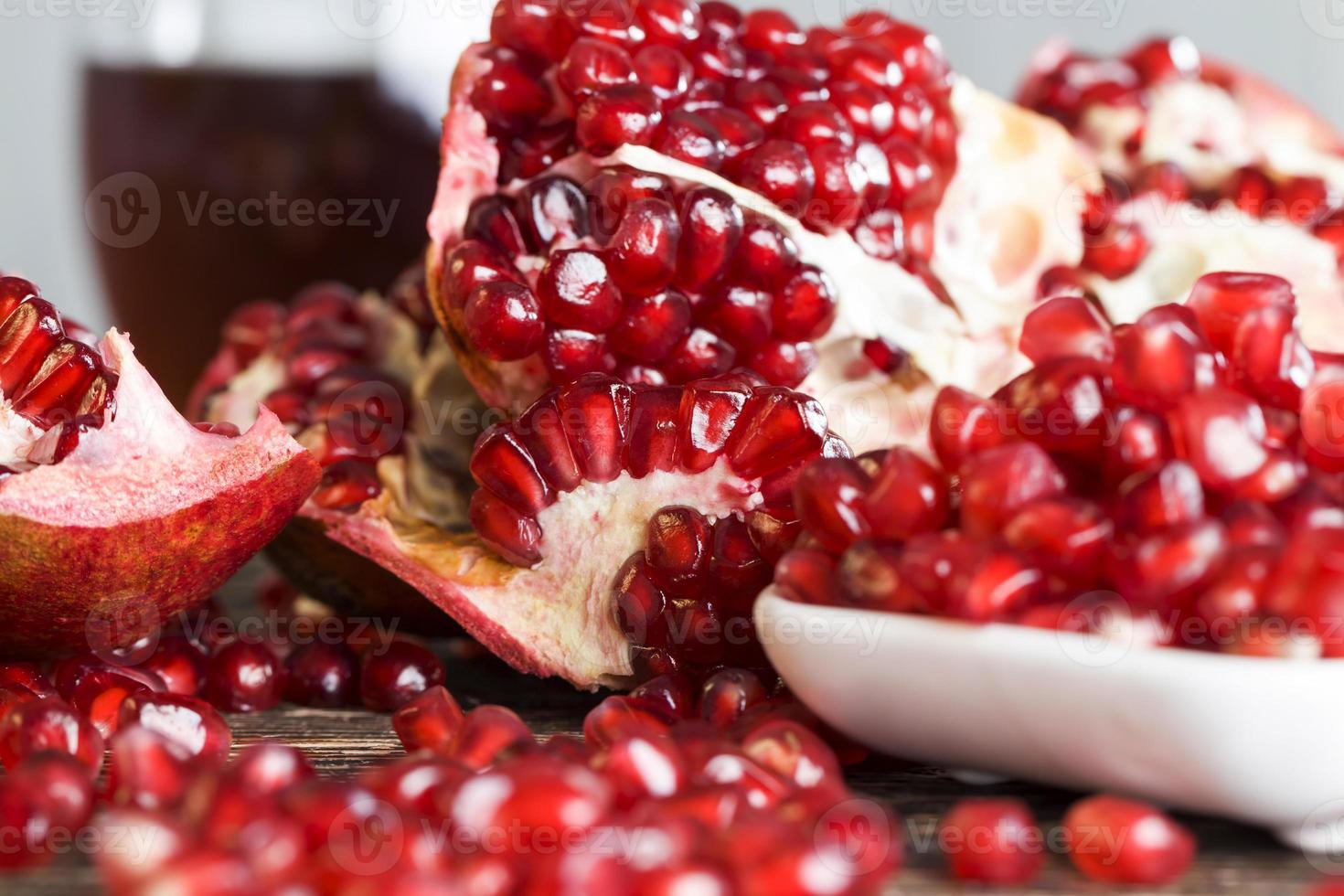 fresh pomegranate seeds on the kitchen table photo