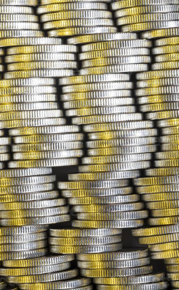 many round metal coins of silver color illuminated with Golden color photo