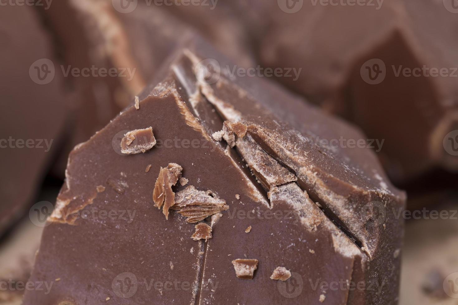 broken into several parts pieces of chocolate from cocoa photo