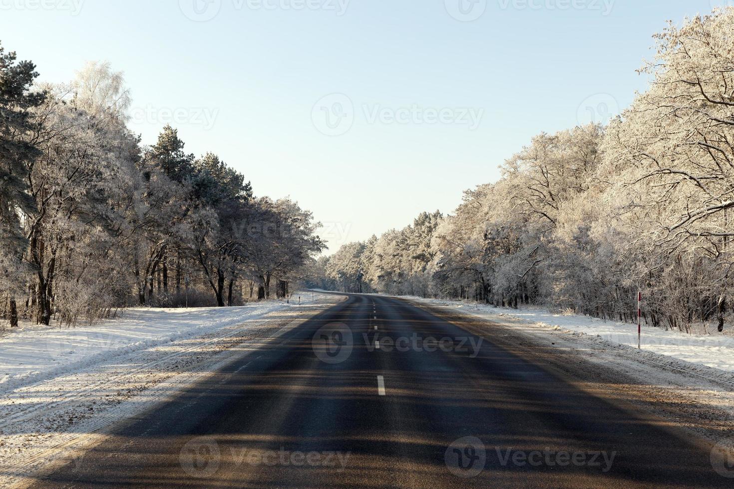 snowfall in the winter season and road asphalted photo