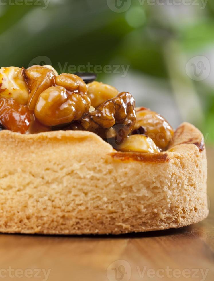 nut tartlet covered with a layer of liquid caramel photo