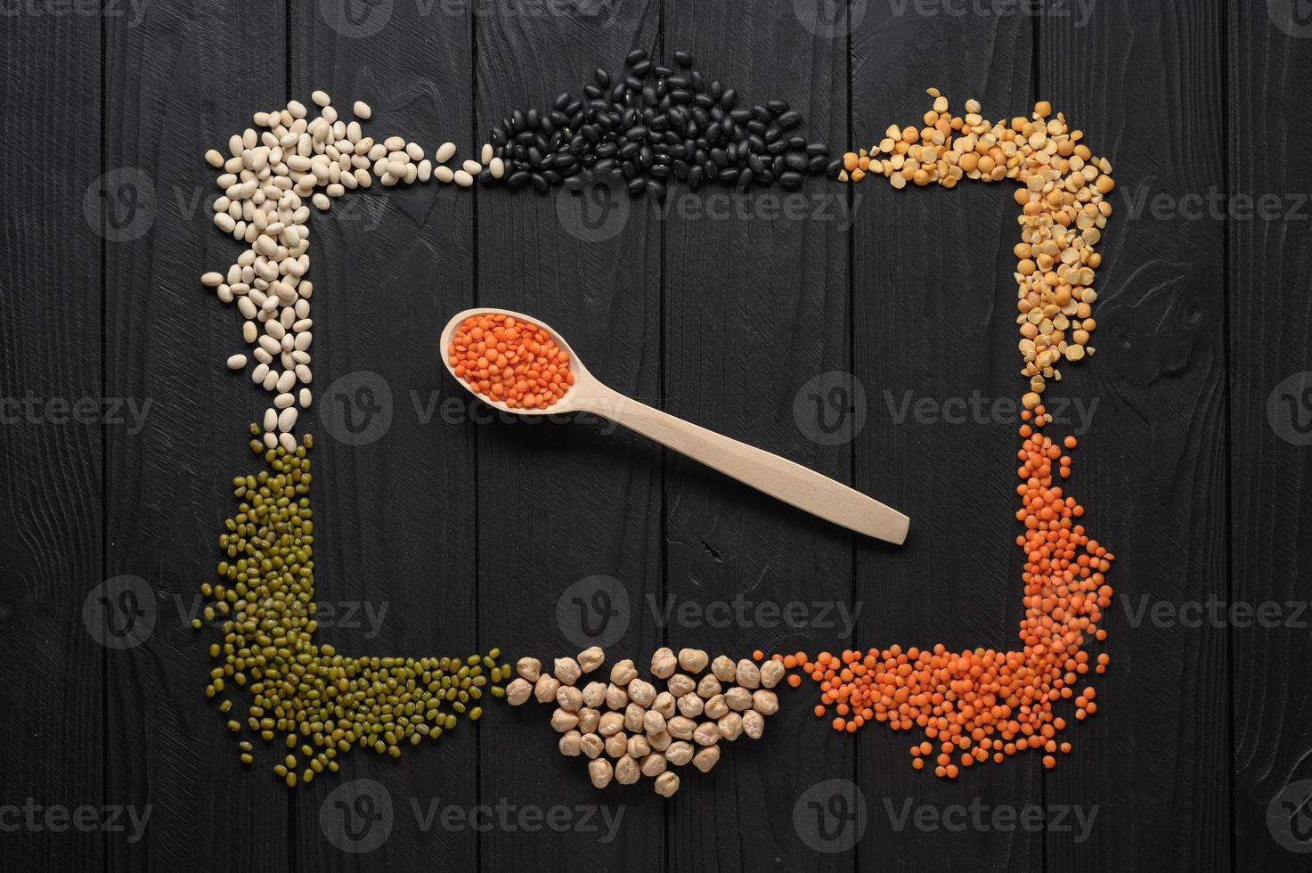 Legumes, overhead flat lay shot on a dark rustic wooden background with a place for text photo