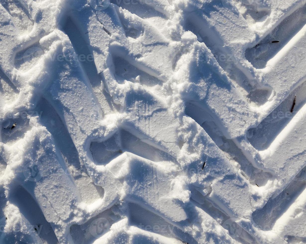 Traces of the car on the snow photo