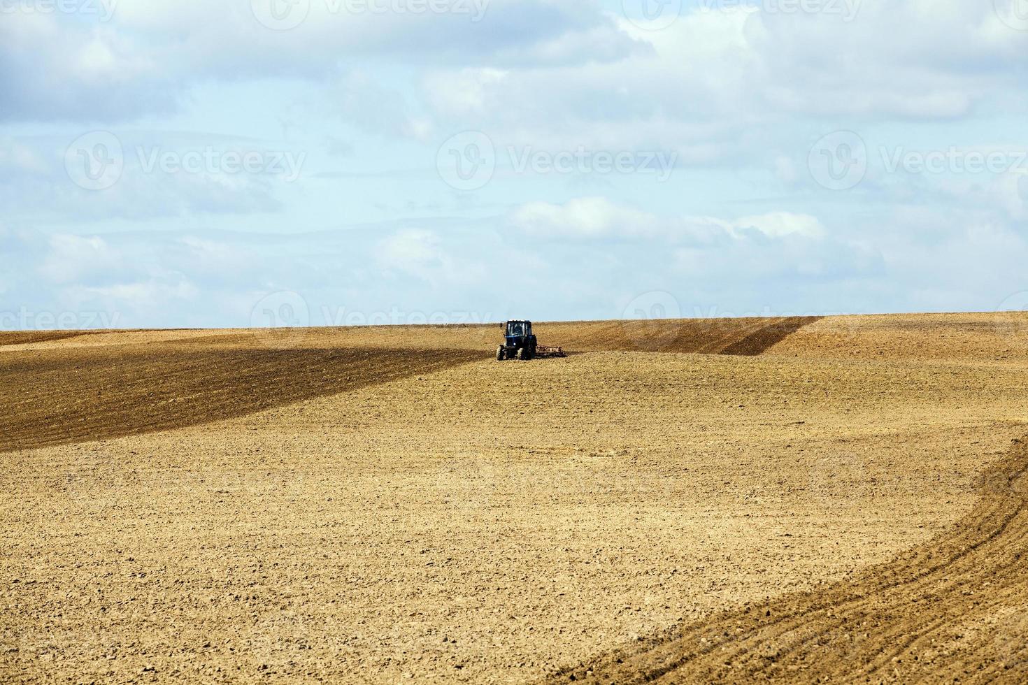 tractor plowing field photo