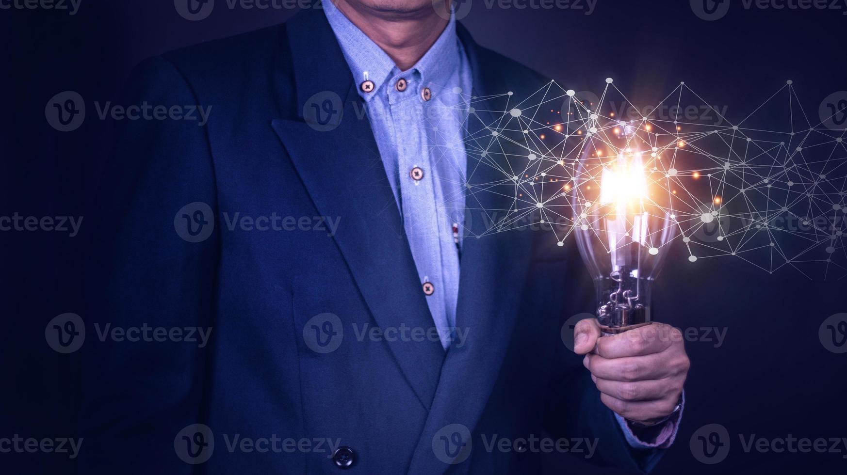 Businessman hand holding light bulb with finance document and tool,concept of New ideas for business and fonance. photo
