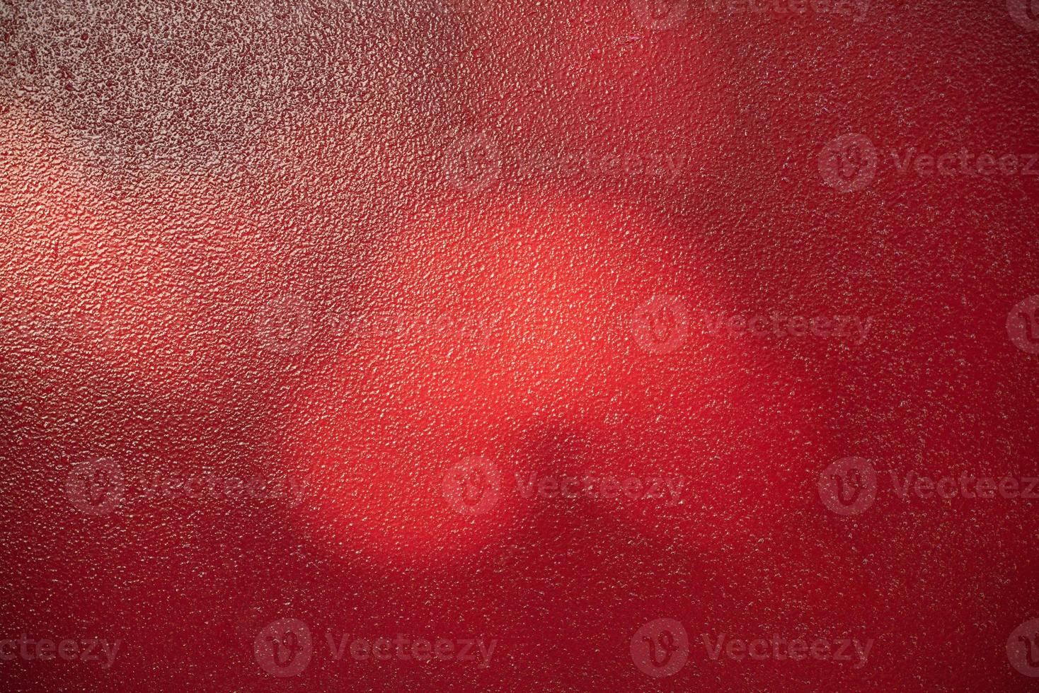 Red metal background. Light and shadow painted with red paint metal texture. photo