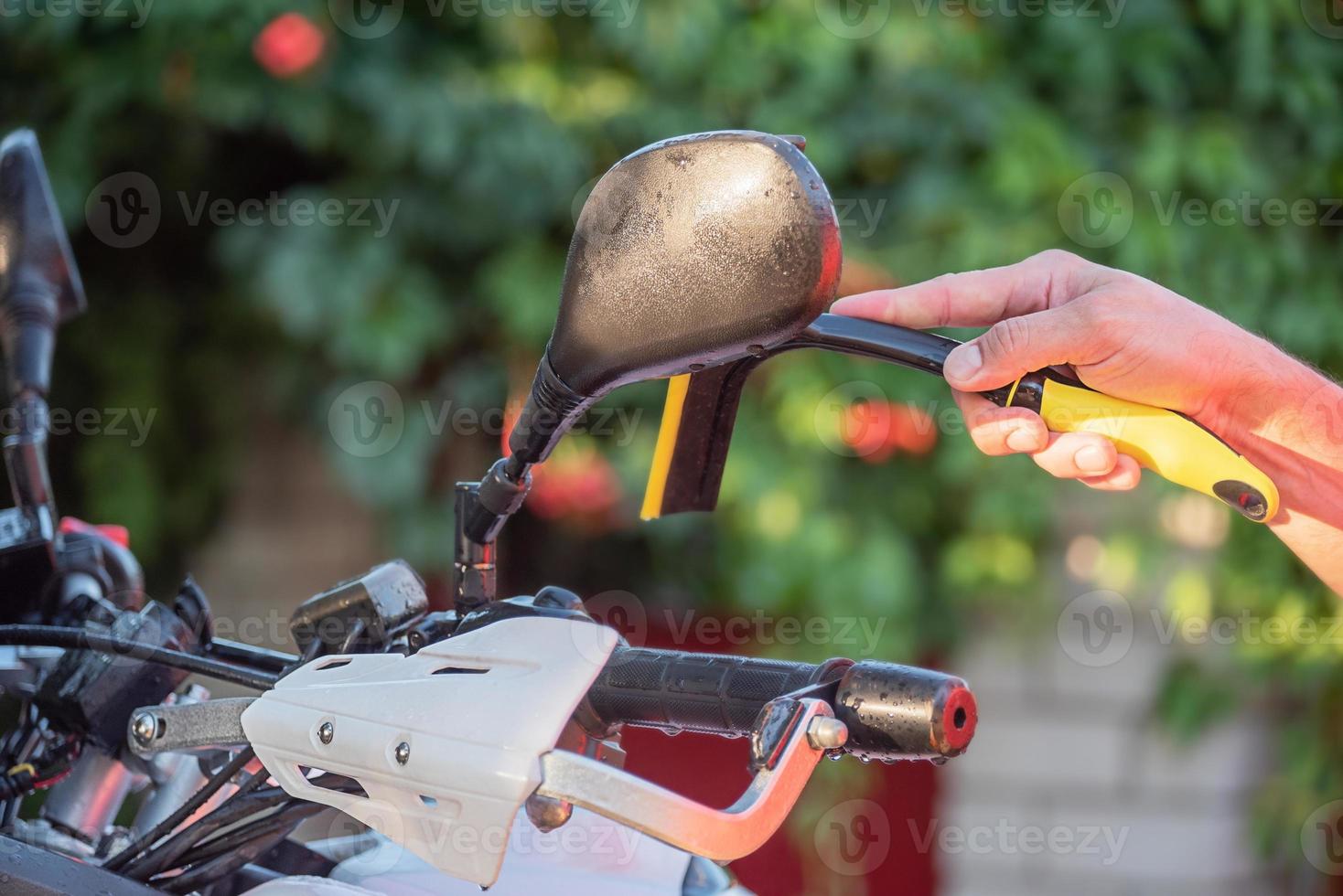 A clean wet motorcycle of the enduro class. Car wash. Wet bike. photo