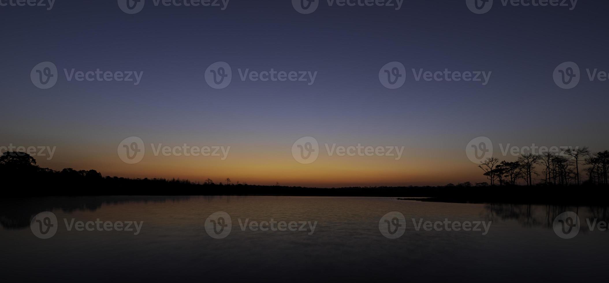 Sun shine over lake or river at sunrise sky. Nature landscape in morning. photo