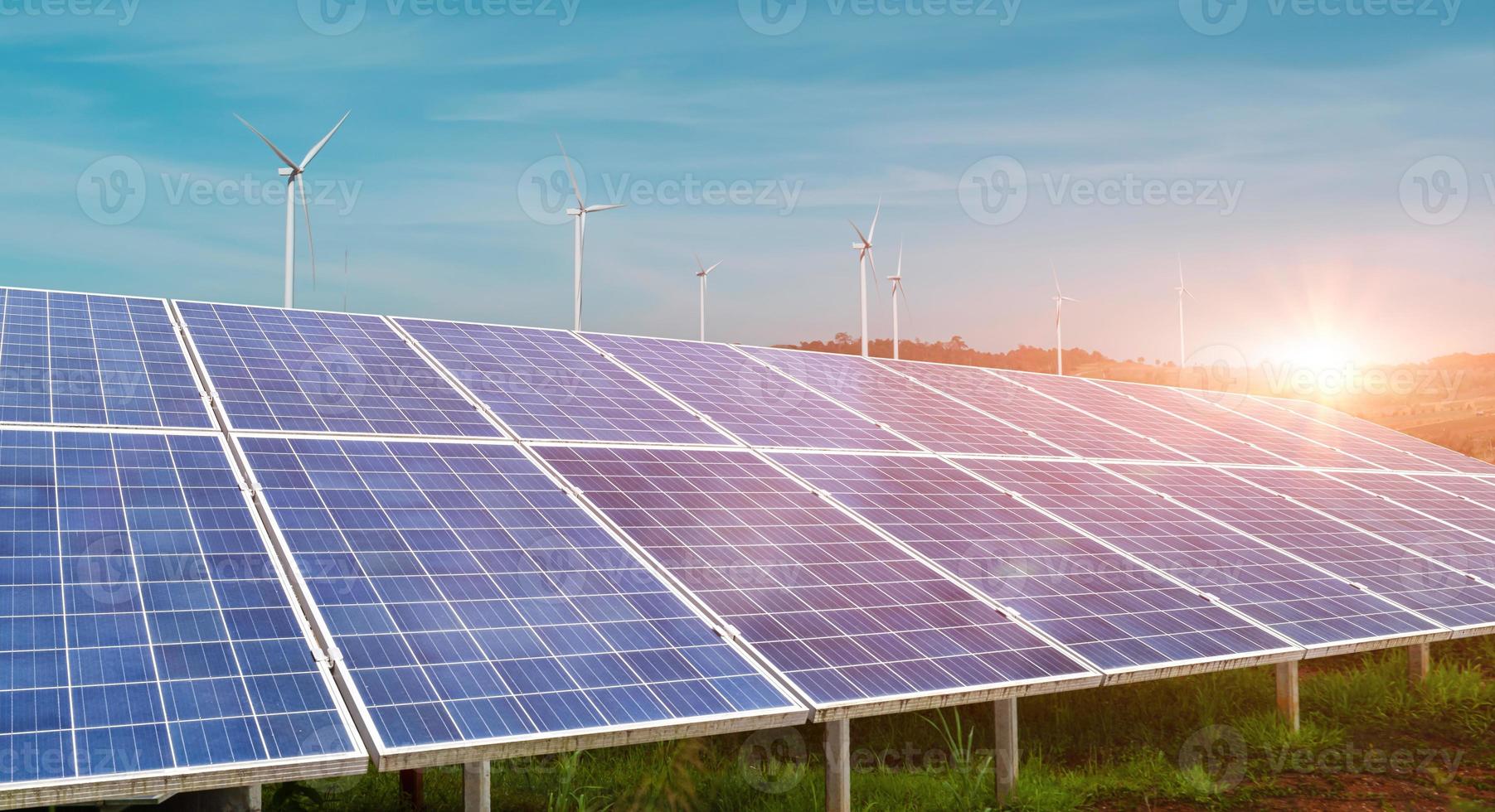 Solar panel with wind turbine against sunset sky background. Photovoltaic, alternative electricity source. sustainable resources concept. photo