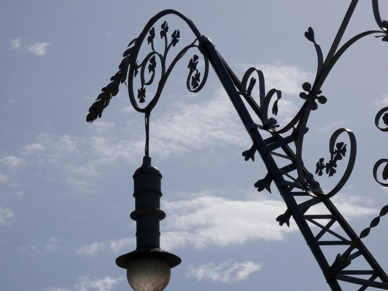 backlit details of a modernist chandelier in the city of Barcelona photo
