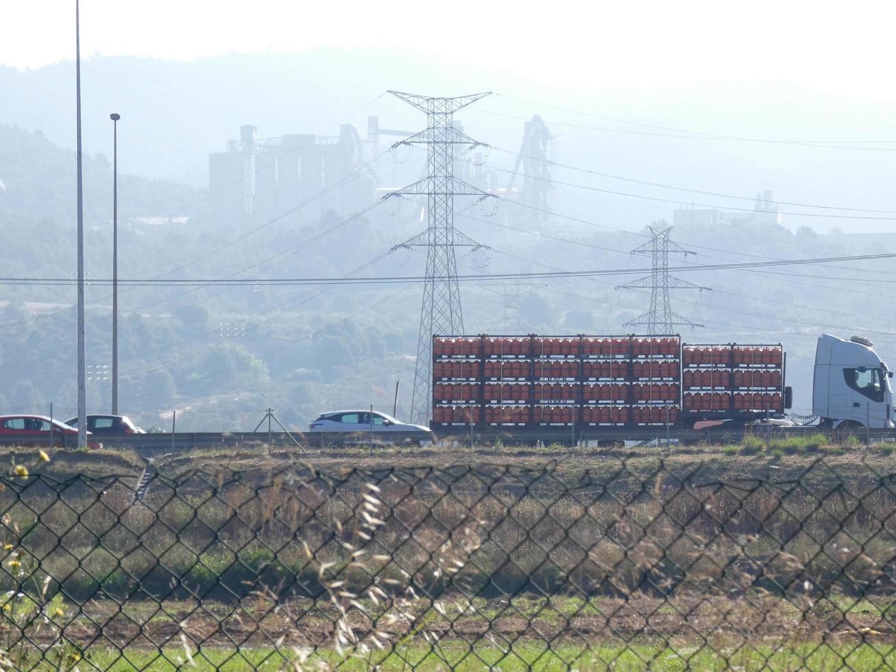 traffic on the highway and high voltage pylons in the background photo