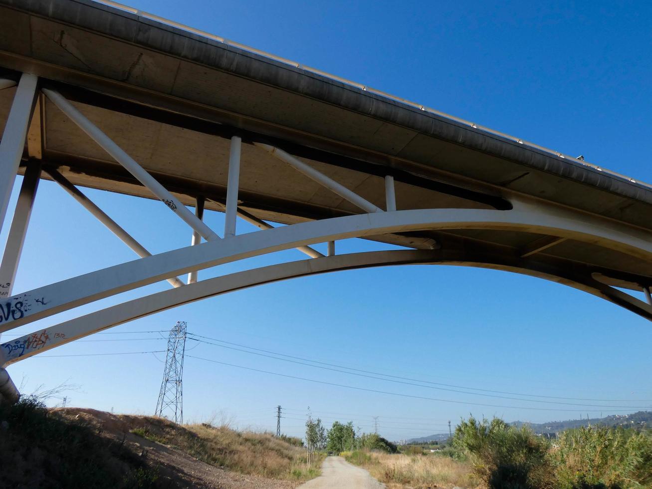 silueta del arco de un puente moderno sobre una carretera foto