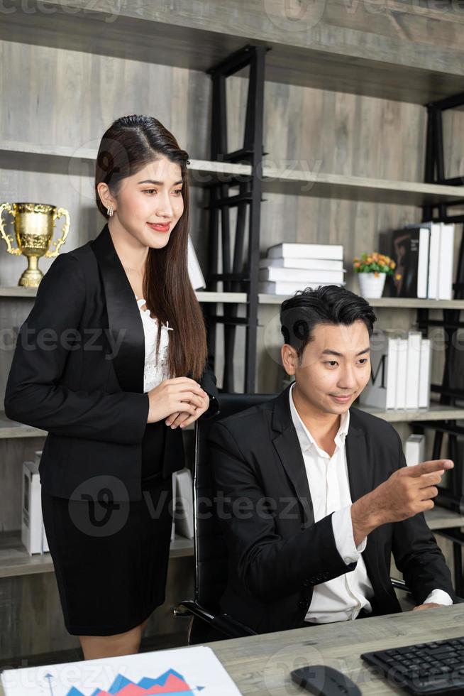 two successful business partners working at meeting in office. Business people working with computer in an office photo