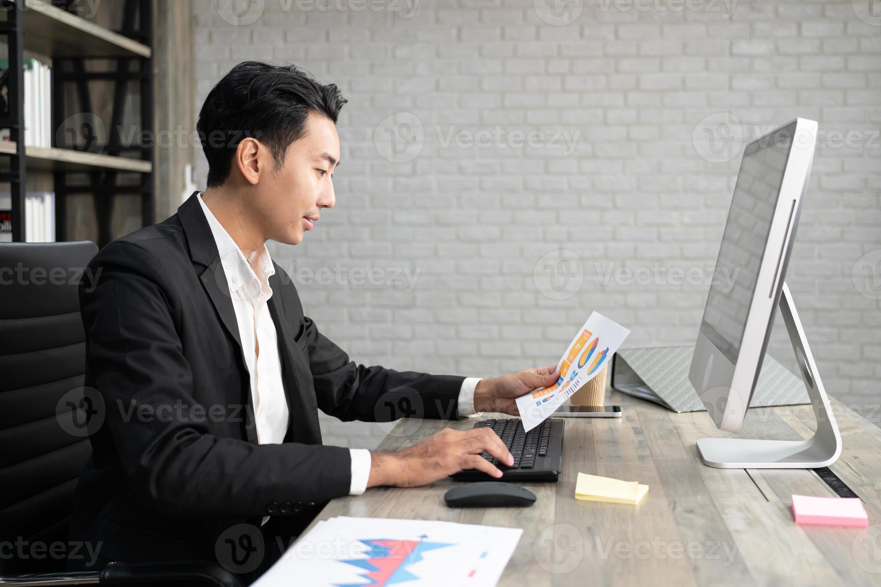 Portrait of business man using computer at workplace in an office ...