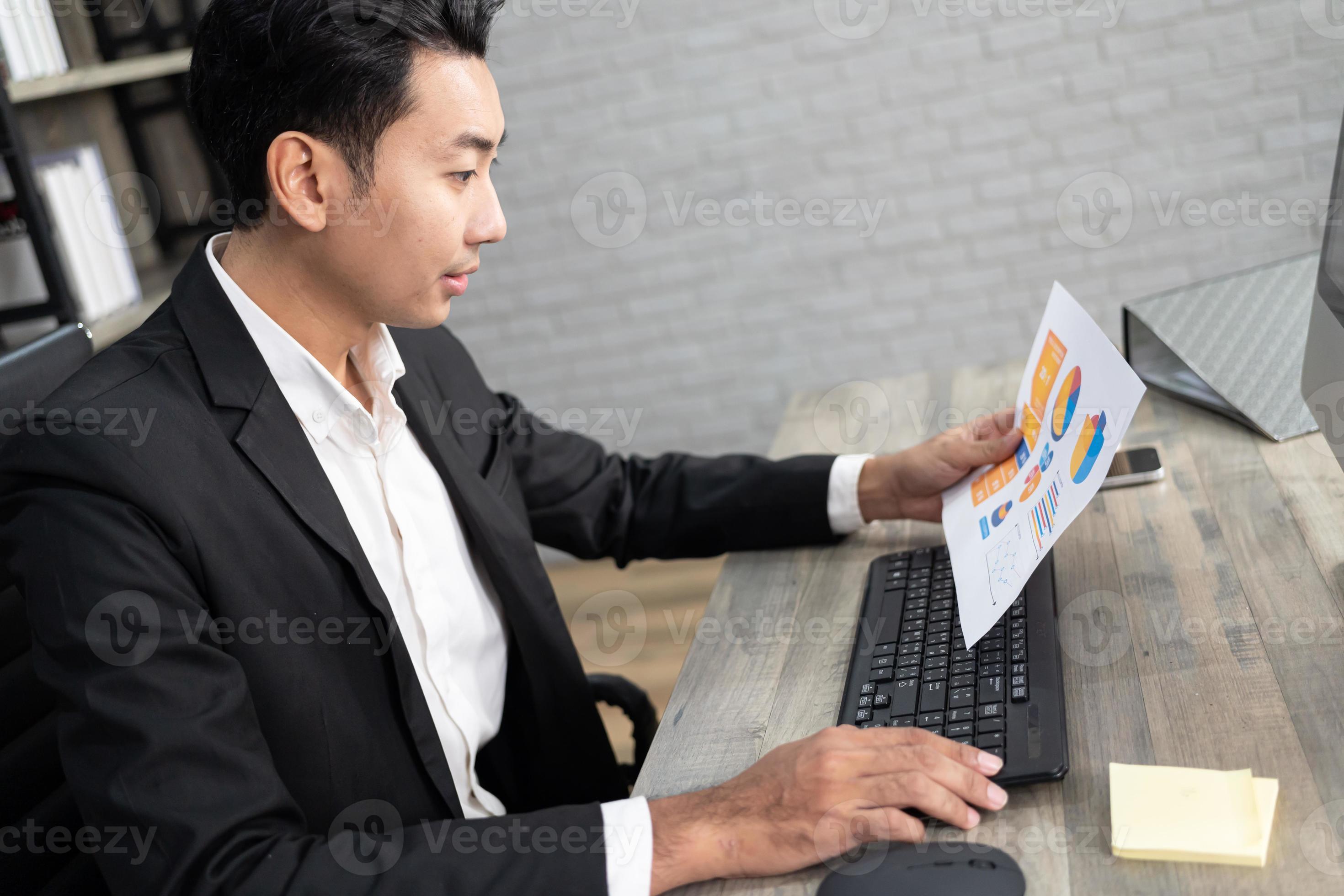 Portrait of business man using computer at workplace in an office ...