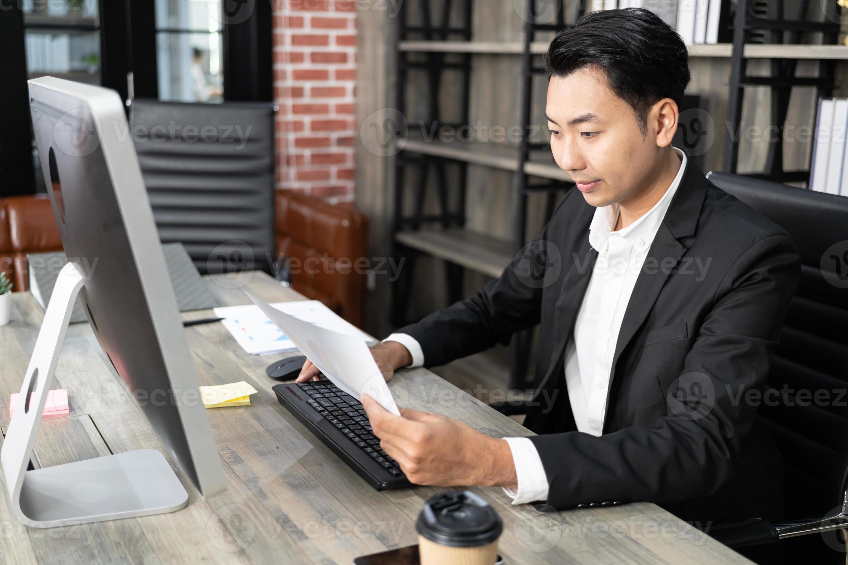 Portrait of business man using computer at workplace in an office ...