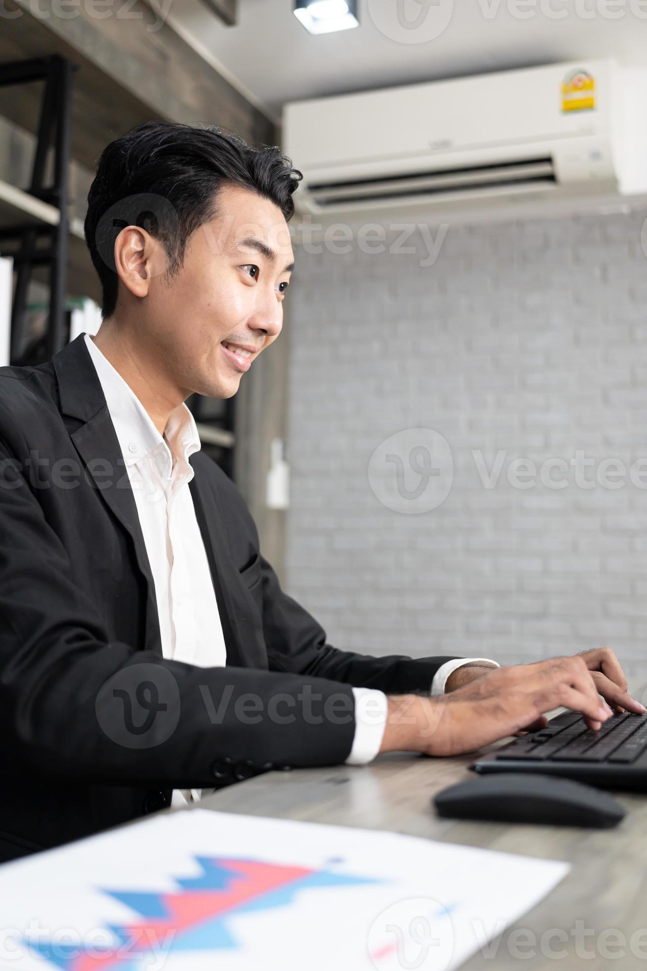 Portrait of business man using computer at workplace in an office ... image.