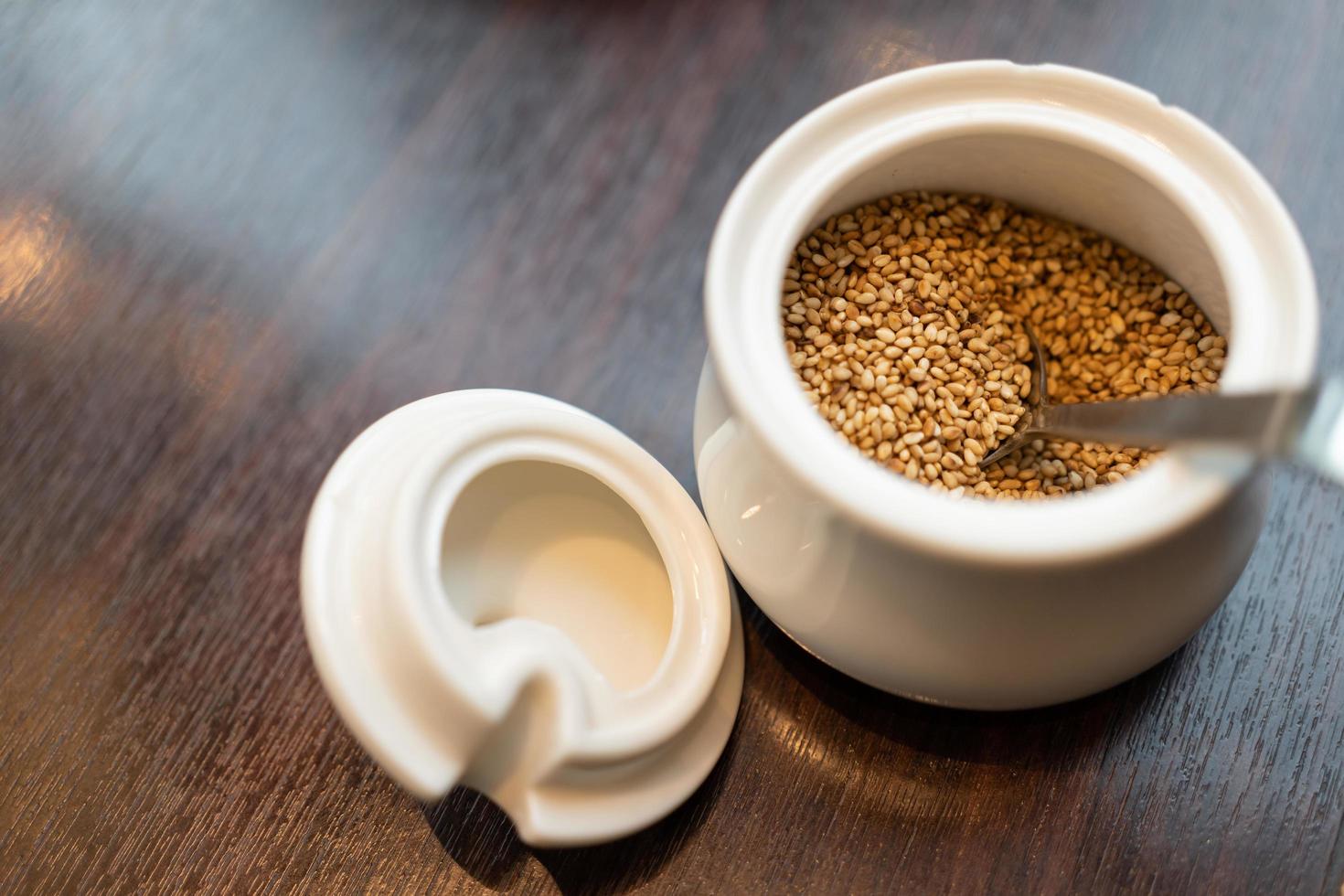 sesame seeds and a wooden dark table. Copy space. photo