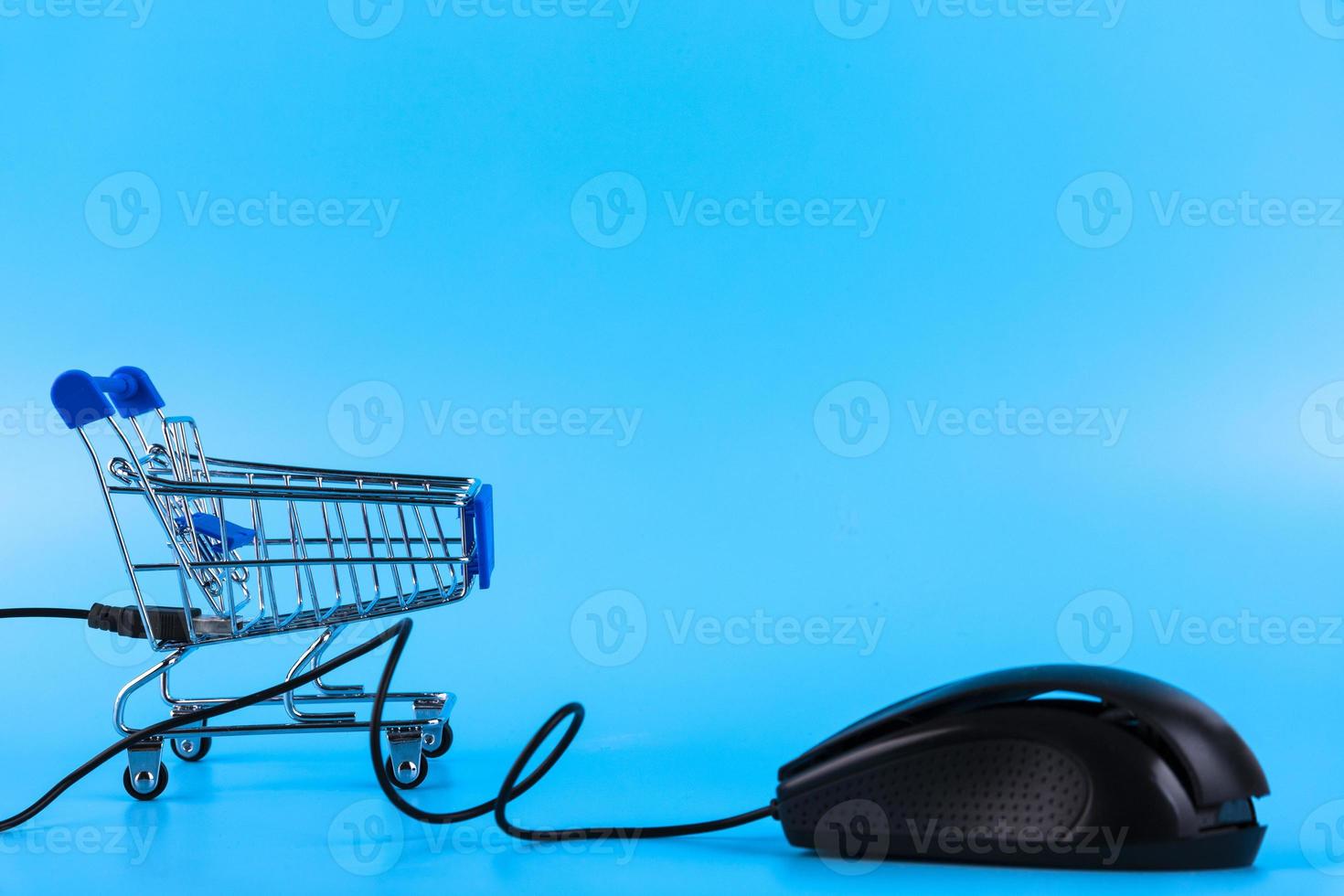 Shopping cart and computer mouse, online shopping concept. Copy space. photo