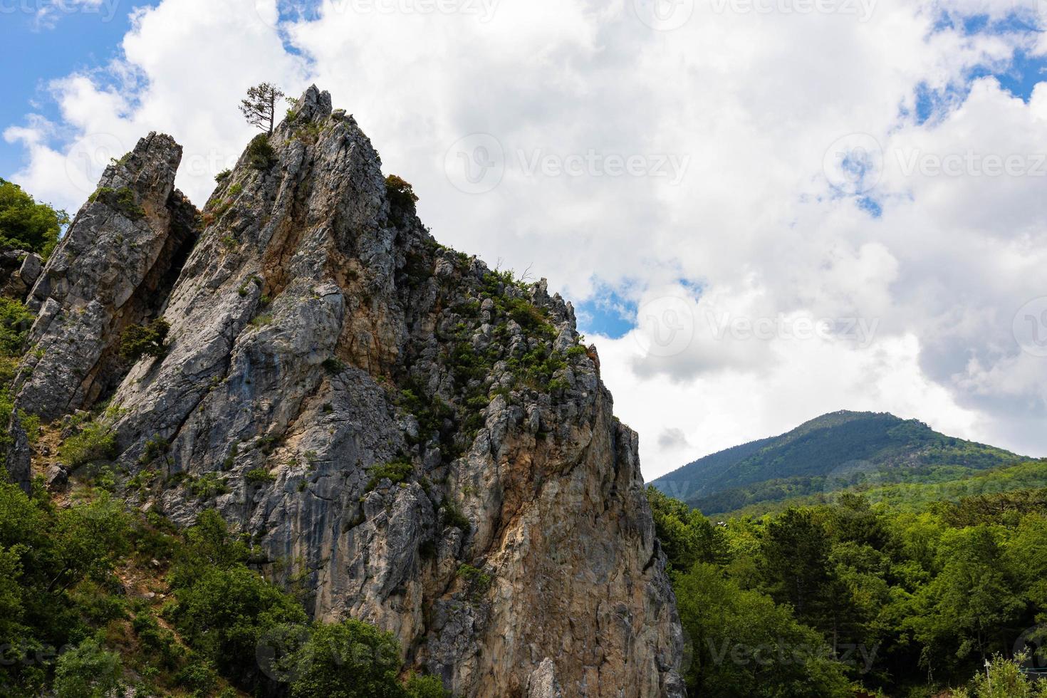 Red rock, cliff in the Gurzuf valley on the southern coast of the Crimea peninsula, located at an altitude of 430 meters above sea level. photo