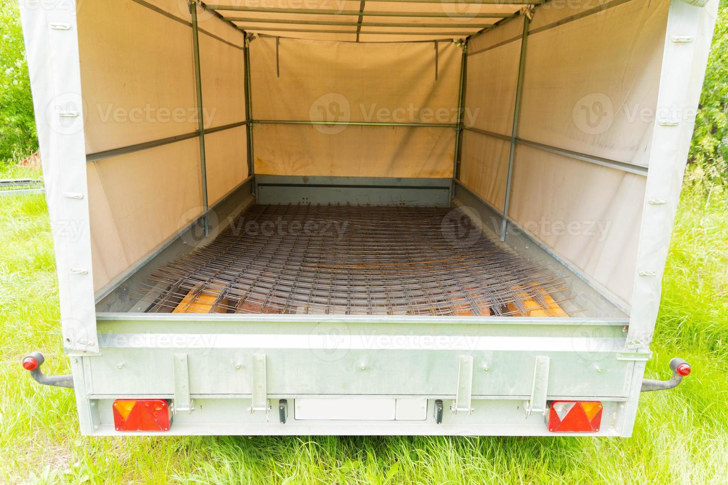 The car trailer is loaded with a reinforcing mesh. photo