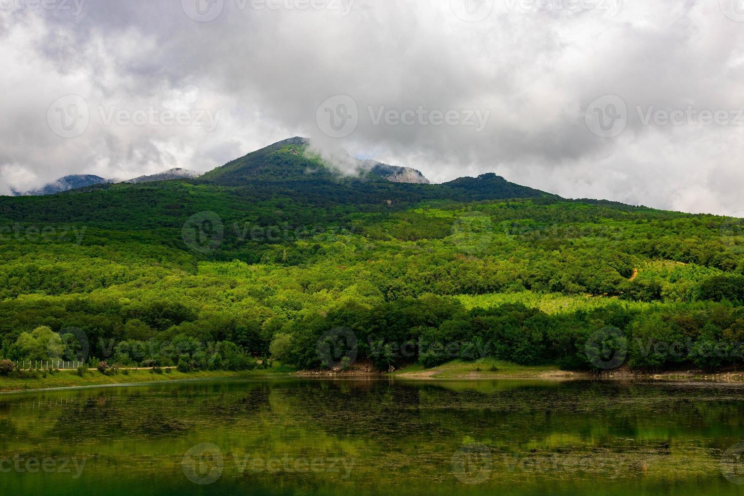 Mountain lake with mountain views and clouds. photo