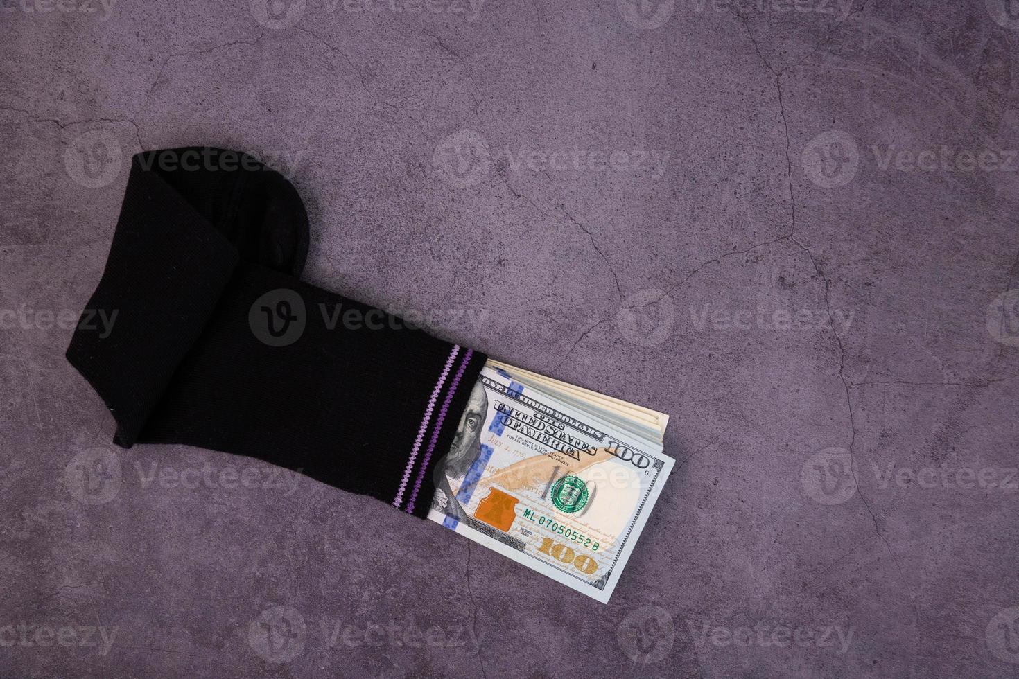 A money sock, a bundle of American hundred dollar bills hidden in a sock. Savings and storage concept. Copy space. photo