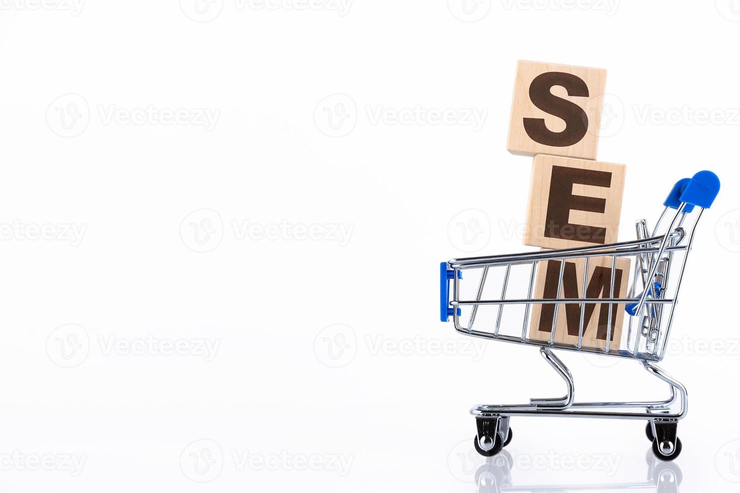 SEM is an acronym for Search Engine Marketing. business concept background, on wooden cubes lying in a shopping cart. Copy space photo
