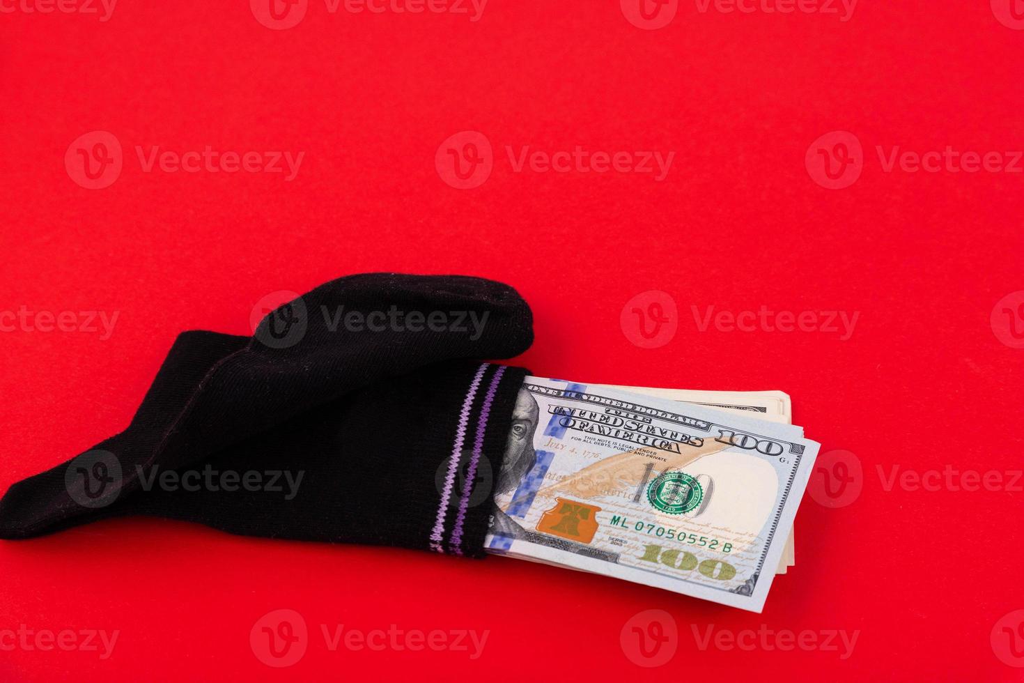 A money sock, a bundle of American hundred dollar bills hidden in a sock. Savings and storage concept. Copy space. photo
